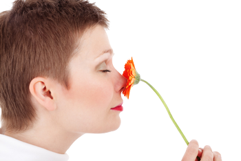 woman smelling flower