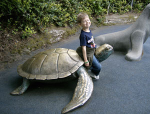 Jacob on a turtle sculpture at the Oregon Aquarium